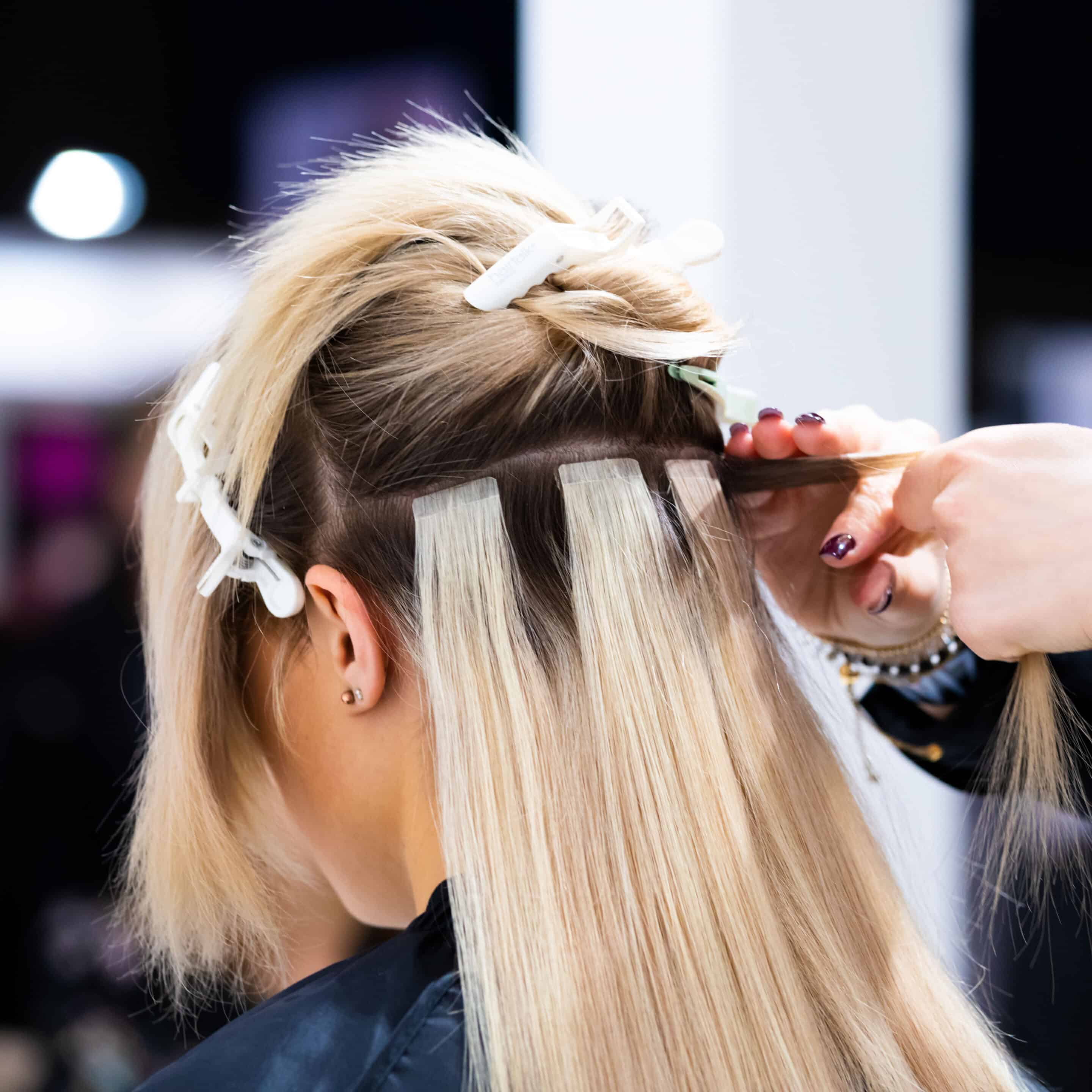 Professional,Hairdresser,Making,Hair,Extensions,For,Blonde,Girl,In,A